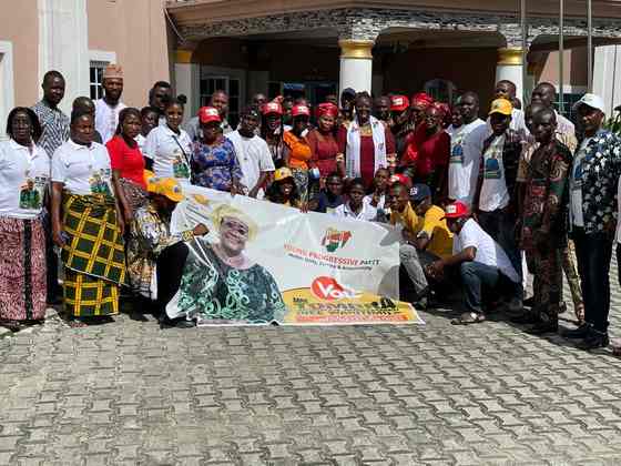 Tombra Mohammed with campaign supporters holding a YPP banner