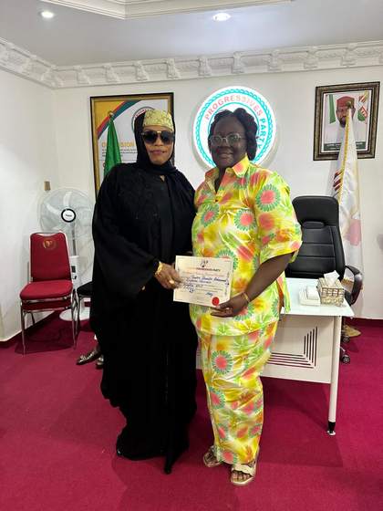 Tombra Mohammed receiving a Young Progressives Party (YPP) certificate